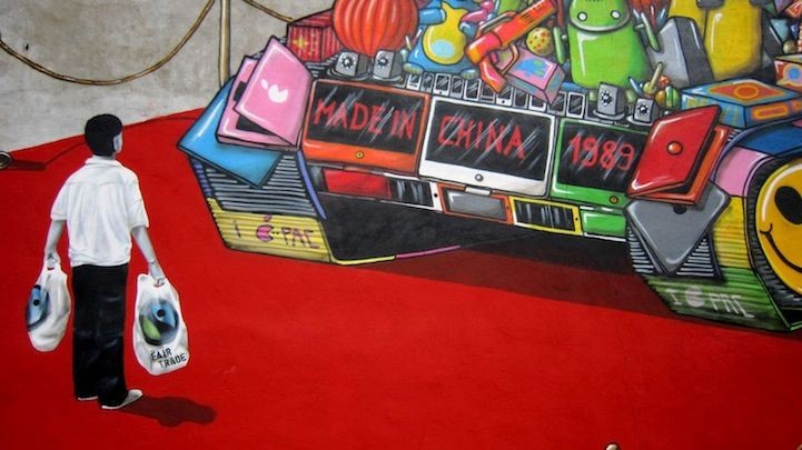 Vibrant street mural featuring a person carrying shopping bags, standing before a colorful boombox emblazoned with 'Made in China 1988', a poignant blend of consumer culture and historical homage.