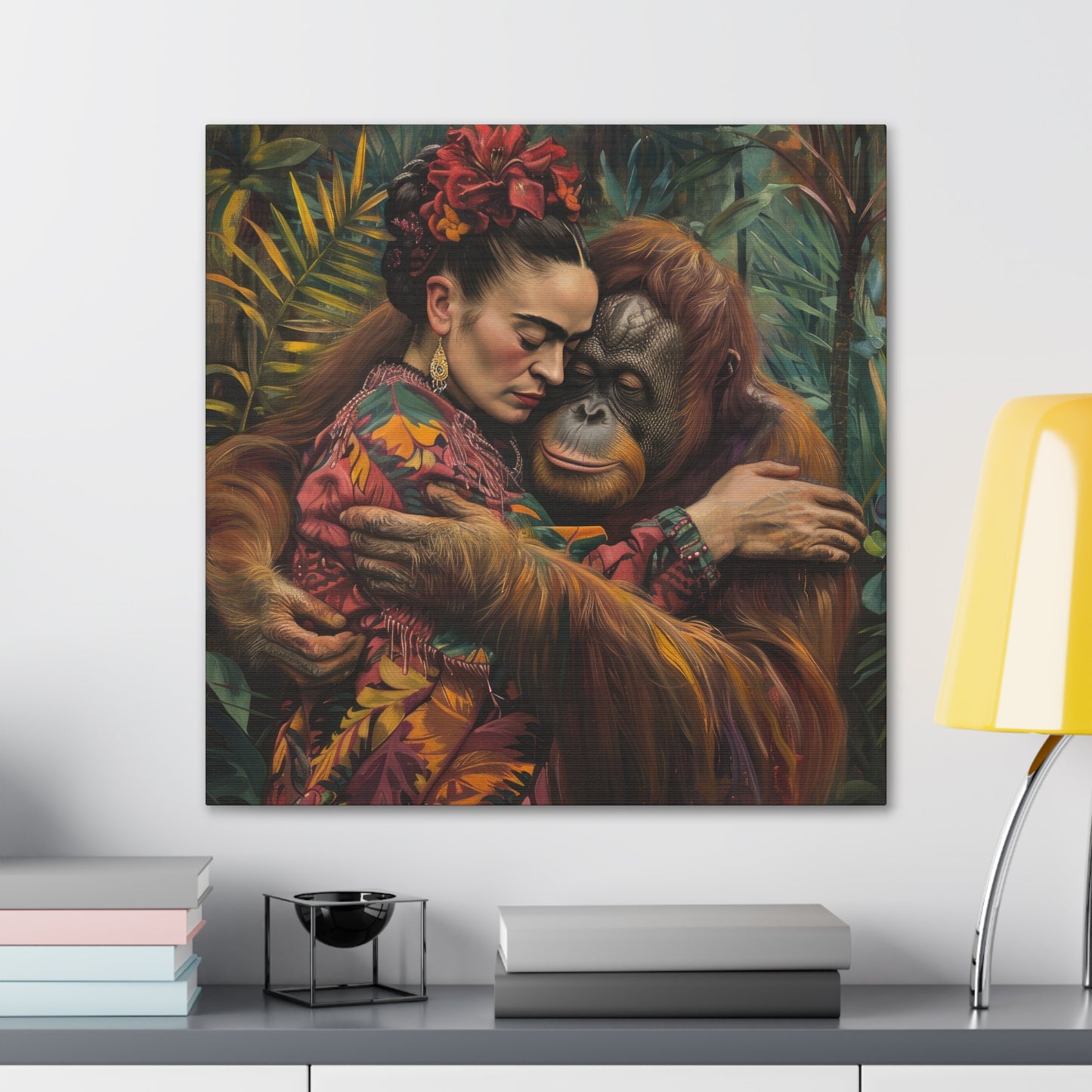 A vibrant Printify canvas print of David Miller's "Embrace of the Wild" artwork, depicting a woman embracing an orangutan, hung on a wall above a desk with books and a lamp.