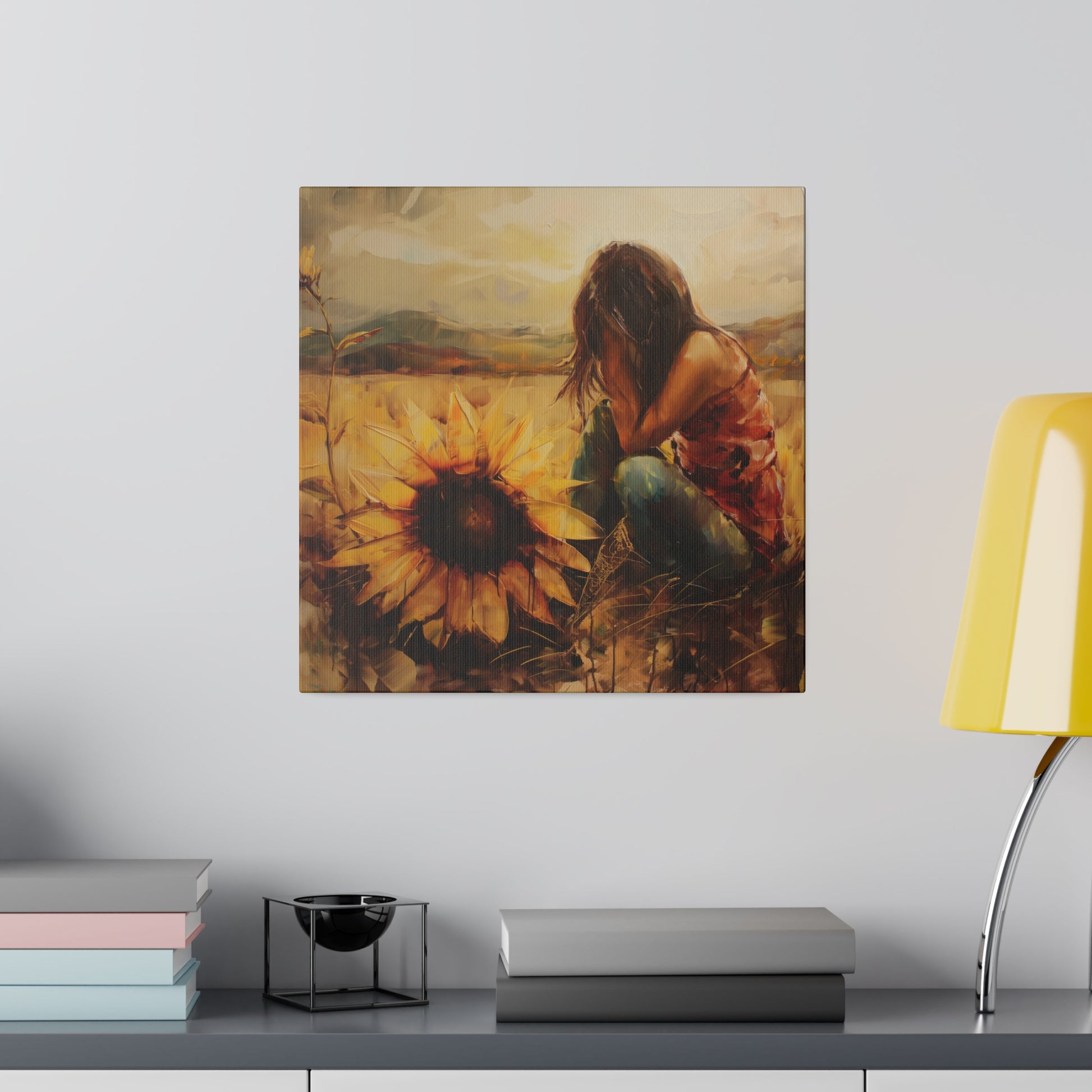 A painting of a person sitting among sunflowers, embodying the human experience, displayed above a shelf with books and a lamp. Elena Duval: Solace in Solitude Exclusive Canvas Print by Printify.