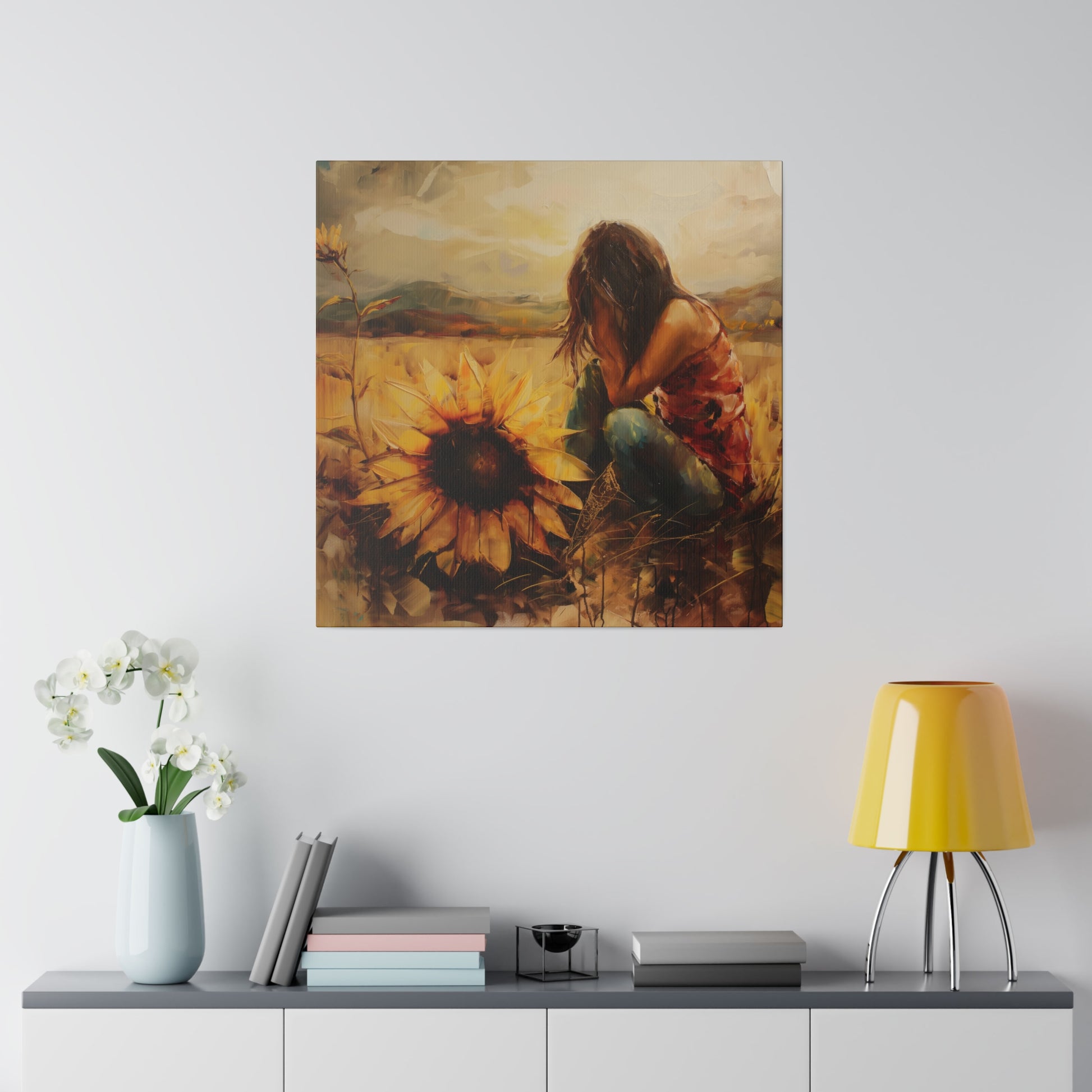 A painting that captures the human experience amidst sunflowers hangs on a wall above a modern sideboard with decorative items. Elena Duval: Solace in Solitude Exclusive Canvas Print by Printify.